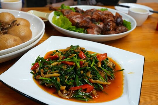 Cantonese cuisine - vegetable stir fry with water spinach served in a restaurant in rural Guangdong, China.