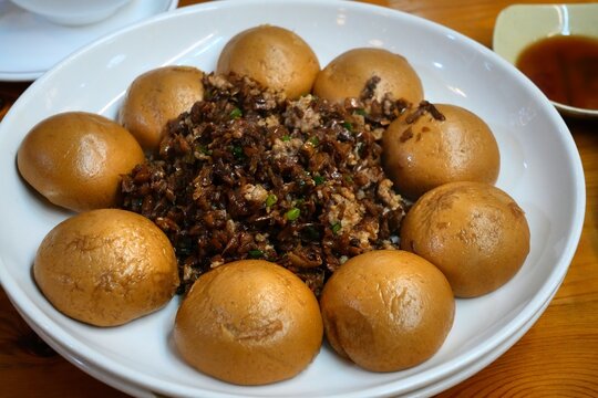 Hunan cuisine - waipo cai stir fry (or wai po cai) served with buckwheat steamed buns (qiaomai wowotou) served in a restaurant in rural Guangdong, China.