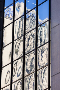 View of rippled Sydney reflections across a glass window grid