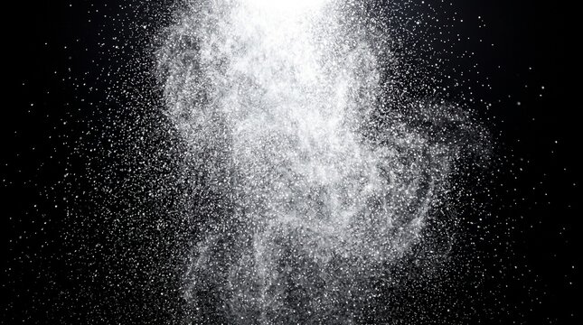 White powder particles exploding against a solid black background with creating abstract explosion effect particles scatter through minimalist