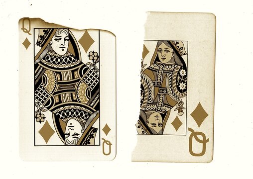 Partly burnt and torn vintage playing cards in sepia isolated on a white background.
