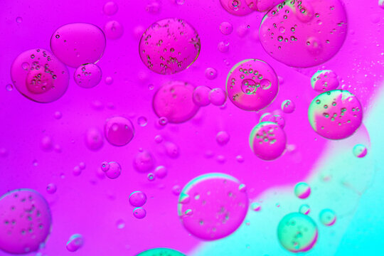 Abstract futuristic biotechnology liquid spheres in vibrant magenta and cyan fluid