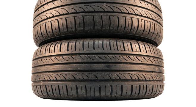 Stack of two car tires on a white background, close-up view of tread patterns