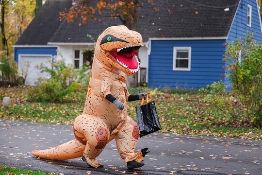 Inflatable Dinosaur Carrying Treat Bag on Halloween