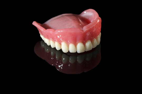 Dentistry tools and models on a black background. 