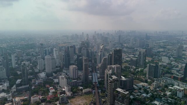 Aerial view of Bangkok, Sukhumvit Road Ekamai area, central streets with dense skyscraper development cityscape.