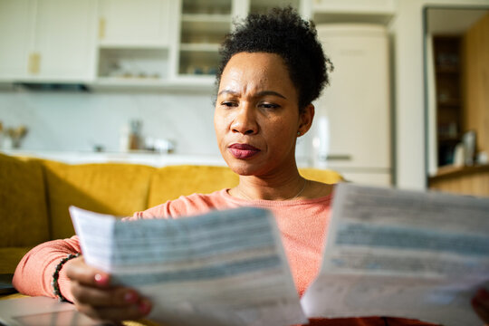 Worried woman reviewing household bills at home