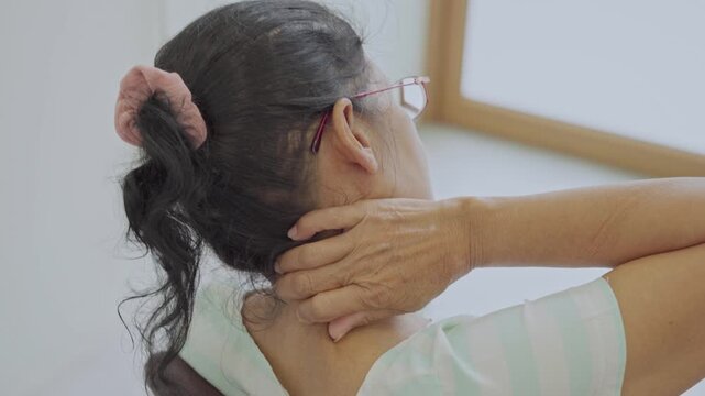 Asian senior woman use hand squeeze nape to relieves symptoms cramps, pain muscle, osteoporosis. Elderly female patient massages shoulder, arm for lifestyle healthcare, arthritis aches. Wellness 