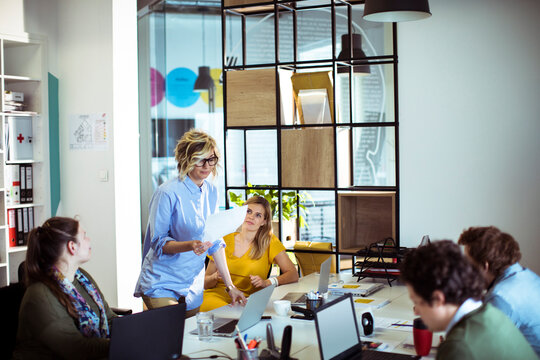 Coworkers in a business meeting at a modern open office