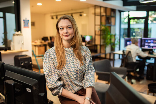 Confident businesswoman posing in modern creative office
