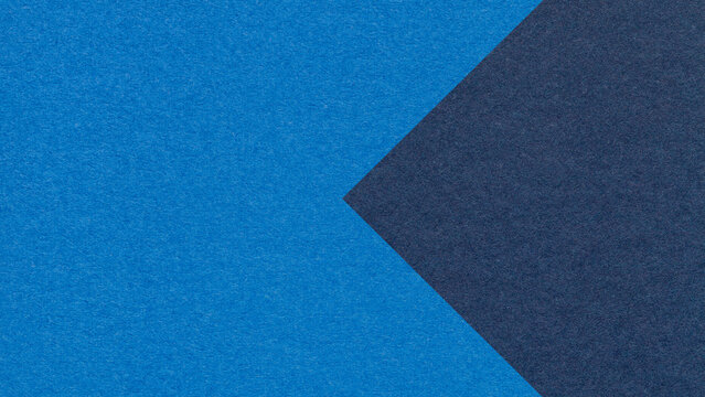 Textured cobalt blue paper background with navy arrow, macro. Template with copy space for banner, presentation
