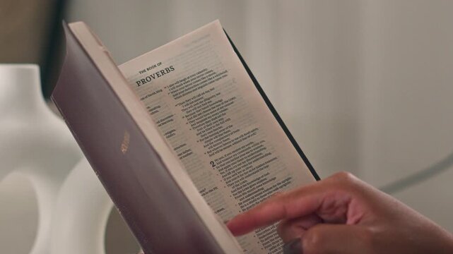 Close Up Woman Reading Holy Bible Book Of Proverbs Pointing At Verse Lines Religious Study Faith Devotion
