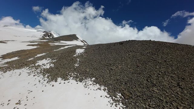 Aerial view of a scree ridge and snow slopes on Mount Aragats