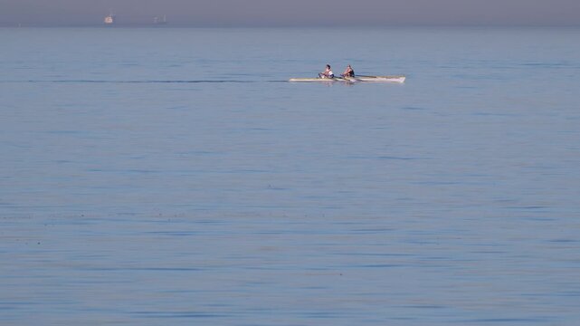Kadikoy, Istanbul, Turkiye - 14 July 2026: View of two people rowing a scull boat on the calm waters of the Caddebostan Coast.