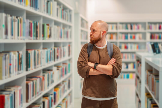 Man browsing between the rows of a library