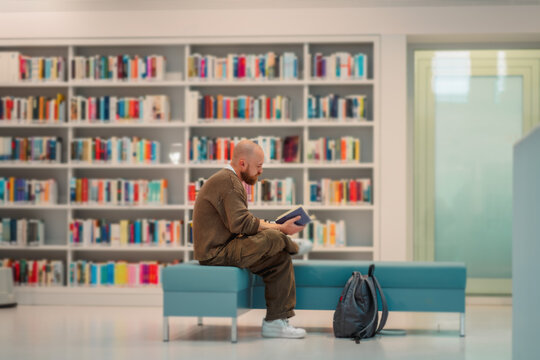 Wide view of a library hall with a single reader