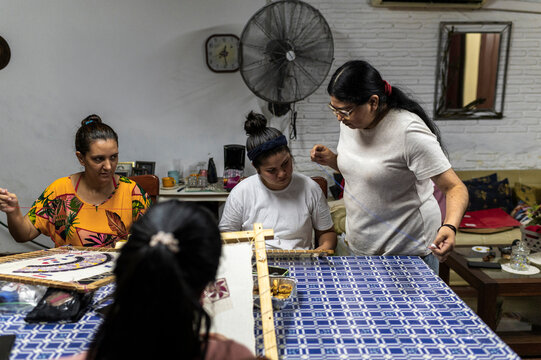 Experienced textile instructor guiding artisan