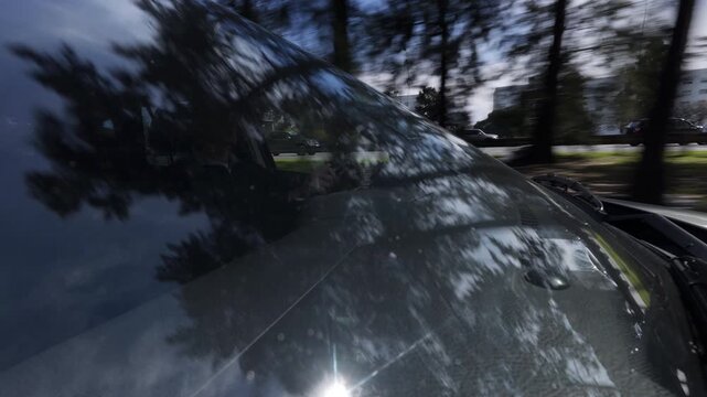 Driving CAR / SUV through city street / road windshield reflection trees sky - DAY