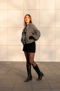 Woman posing outdoors in warm sunlight