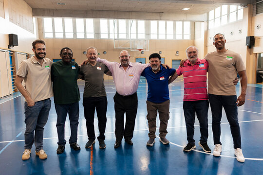 Diverse men smiling together collaborating at community event