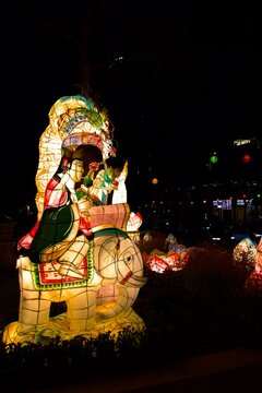 Illuminated traditional Korean figure lanterns glowing at night