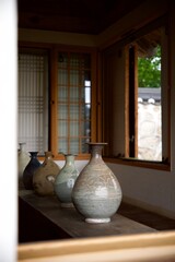 Traditional Korean ceramic vases on a wooden bench