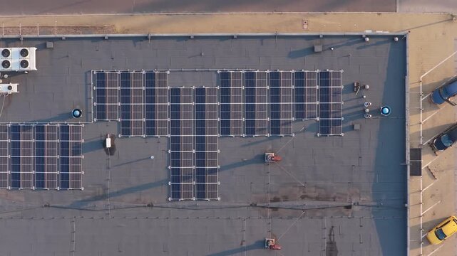 Aerial drone flying over rooftop solar panels