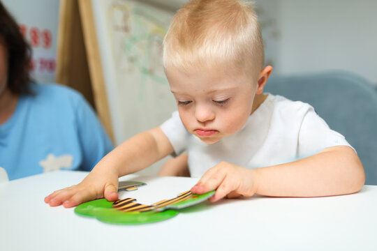 The family is spending time at home with a child with Down syndrome.