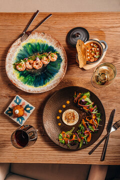 Vertical flatlay of a modern restaurant table with assorted gourmet di