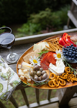 Wine and charcuterie ready and setup on a balcony to enjoy.