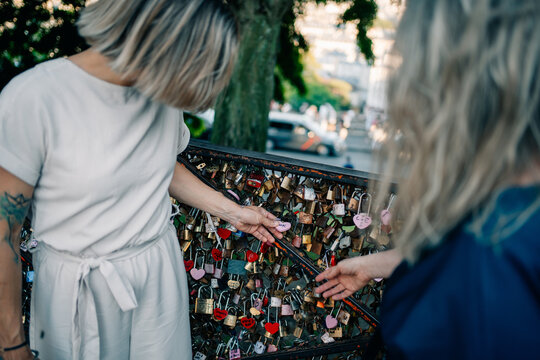 Tourists Visit Love Lock Wall in a City Park During the Day