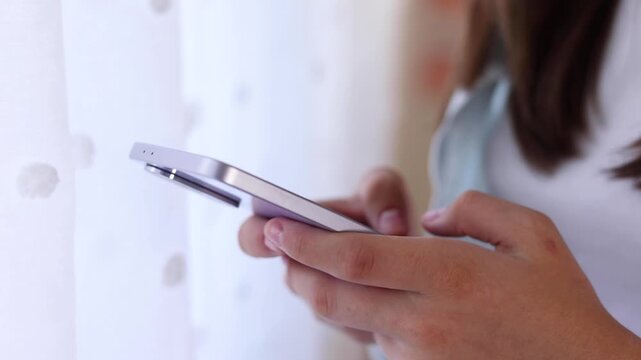Close up of a woman using a smartphone for communication, browsing, social media, online activities and digital interaction.