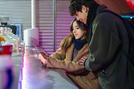 Couple deciding their order at street food place