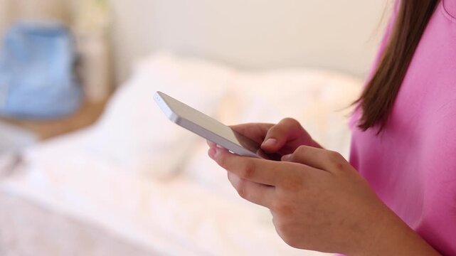 Close up of a woman using a smartphone for communication, browsing, social media, online activities and digital interaction.
