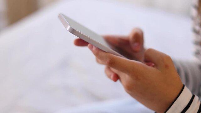 Close up of a woman using a smartphone for communication, browsing, social media, online activities and digital interaction.