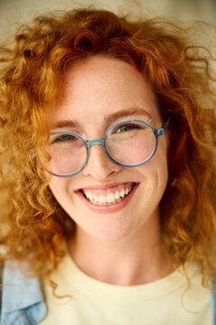 Portrait of a beautiful woman with glasses smiling at the camera
