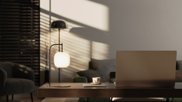 Modern home office workspace with laptop and warm evening lighting