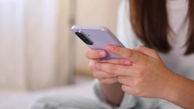 Close up of a woman using a smartphone for communication, browsing, social media, online activities and digital interaction.