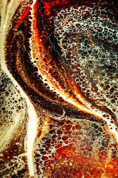 Water Bubbles on a Surface With Brown and White Patterns