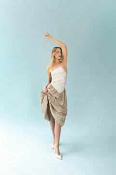 Full Length Fashion Portrait of Blonde Model Posing in Asymmetric Silk