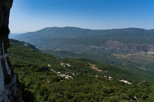 Dabovici, Opstina Danilovgrad, Montenegro - 21 June 2025: View of the lush green Bjelopavlici valley and surrounding mountains as seen from the historic Ostrog Monastery.