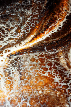 Water Bubbles on a Surface With Brown and White Patterns