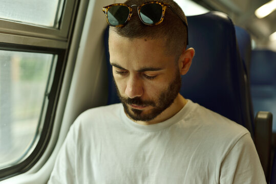 Thoughtful Young Man Lost in Thought During a Train Journey