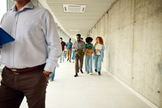 Group of students walks through the corridor of the faculty