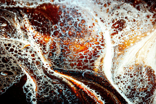 Water Bubbles on a Surface With Brown and White Patterns