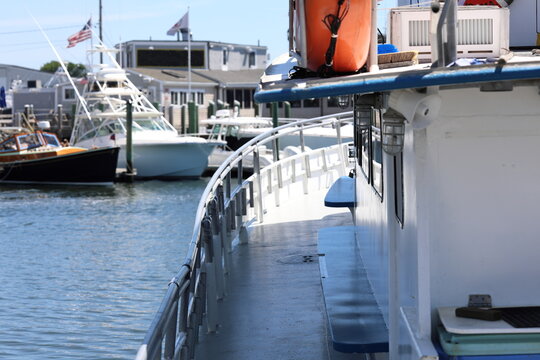 Fishing stations and bench along the gunwale port side of a fishing charter boat