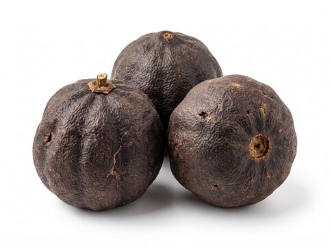 Three whole dried black limes, also known as loomi or limoo amani, isolated on white background, traditional spice used in Persian and Middle Eastern cuisine