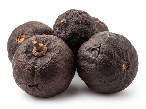 Group of dried black limes or loomi isolated on white background, traditional sour spice used in Persian and Middle Eastern cuisine for flavorful cooking
