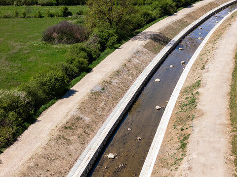 Aerial view of river management showing channel cleaning and widening activities. Location focuses on flood protection measures.