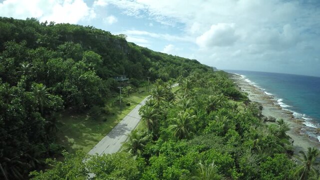 Aerial drone footage, coastal island road, Rota, Mariana Islands	